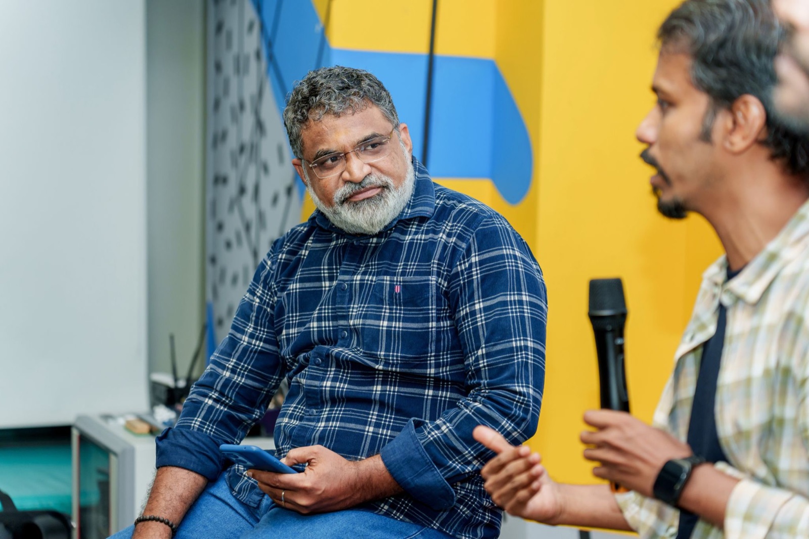 Ramesh Natarajan listening as Raja T M speaks during the Brand Conference panel